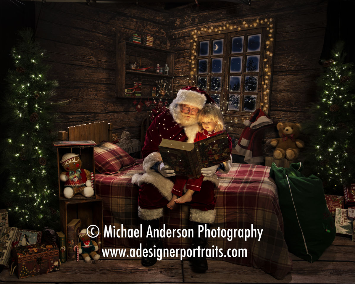 Santa reads "The Night Before Christmas" to an adorable two-year-old. Image was created at The Best Santa Experience at Michael Anderson Photography in Mounds View, MN.
