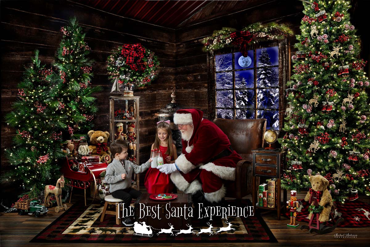 A cute brother and sister enjoy milk and cookies with Santa inside Santa's Cabin!