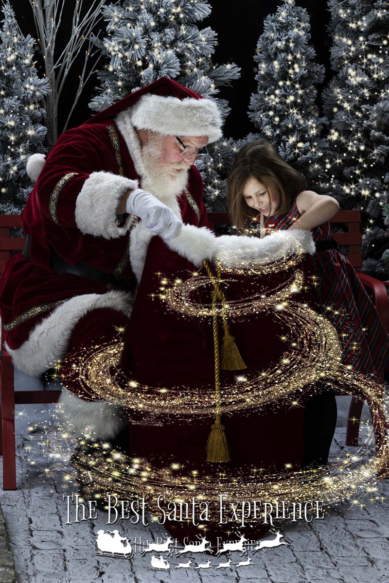 An excited little girl takes a peek into Santa's Magic Toy Bag at The Best Santa Experience.