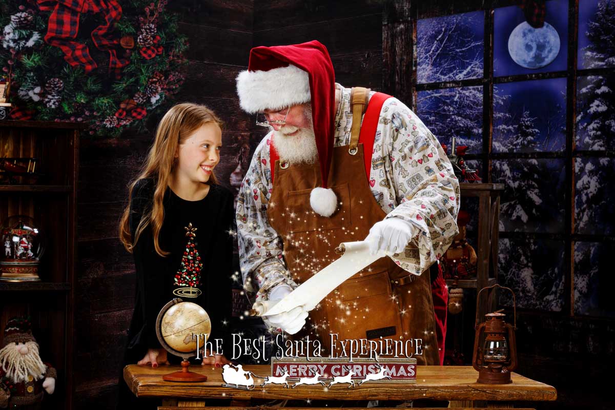 A young girl finds her name on Santa's Nice List at The Best Santa Experience!
