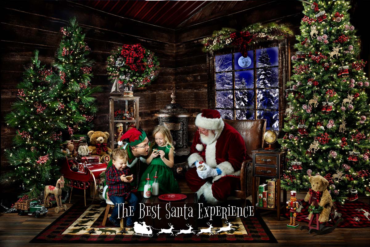 Two cute kids, Santa, and one of his elves share milk and cookies in Santa's Cabin!