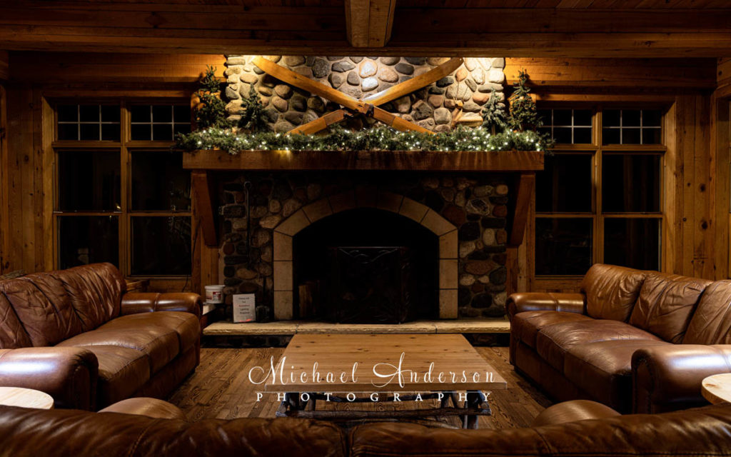 A night photo of the lobby fireplace at Cove Point Lodge in Beaver Bay, Minnesota.